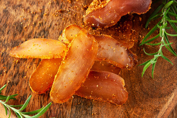 Seasoned chicken with hot sauce and a sprig of rosemary