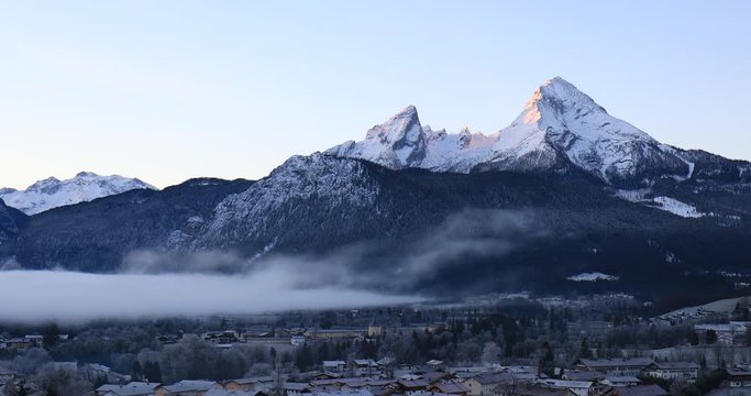 sunrise on Mountain Watzmann in Berchtesgaden with clouds and fog in winter