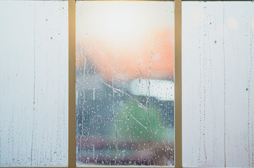 Heavy rain drops on the glass. Close up of a window with rain drops falling down windows. Focus on rain drops. concept of sadness