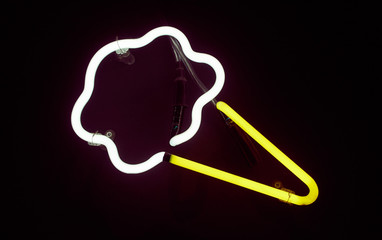 A vintage retro american style neon sign advertising ice cream cone fast food. A dark setting with neon tube lighting up the dark . Food advertising and signage in the food industry