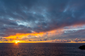 Amazing sunset with colorful clouds and dark ocean water, nature background