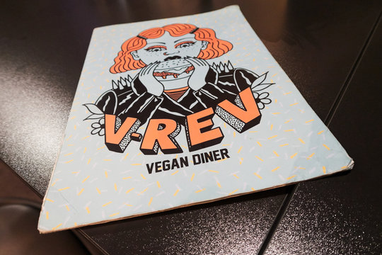 MANCHESTER, ENGLAND, 05/05/2019 Vegan and vegetarian menu in a restaurant and diner in manchester serving delicious creative healthy food. fashionable hipster style decorated restaurant.
