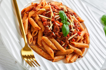pasta bolognese topped with parmesan and basil