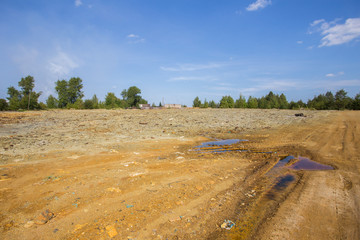 Dull landscape on abandoned mining site with surface dump