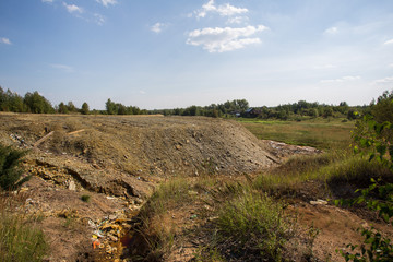 Dull landscape on abandoned mining site with surface dump