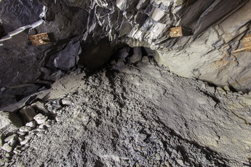 Underground iron mine tunnel with ore heap