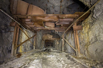 Fototapeta na wymiar Scoop ramp scraper slide in gold mine underground tunnel