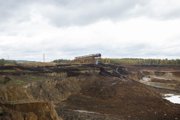 Fototapeta na wymiar Gold sand works gravel mine open pit with giant nozzle hydraulic excavator wash plant