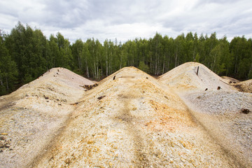 Dull landscape on abandoned mining site with surface dump
