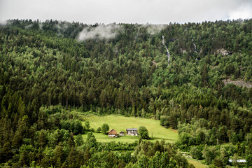 waterfall and tiny village in the countryside of norway