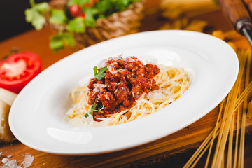 Spaghetti bolognese with tomato sauce, minced meat and grated parmesan cheese. Italian pasta.