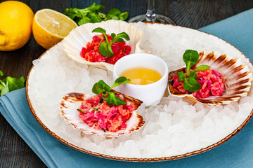 Ceviche. Finely chopped raw tuna and salmon marinated in lemon juice served in seashell.