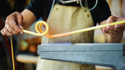 Concept of handmade, high quality, artisan. Production of neon tubes. gas burner. detail of craft and craftsmanship