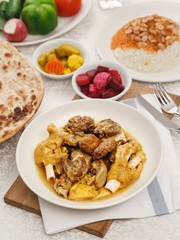 Authentic IRAQI cuisine. Traditional dishes for arabic family dinner. Fried meat kebab with pickles and hummus and bread.  Mix grill saj.