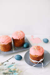 Easter table with Easter cakes, painted eggs and tree branches. Kulich decorated with icing.  Happy Easter concept
