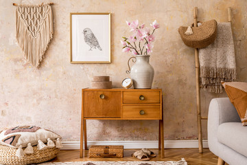 Modern retro composition of living room with wooden vintage commode, sofa, rattan pouf, ladder,...