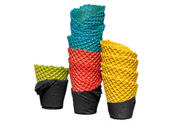several colorful delicious ice cream waffle cups wrapped in black napkins