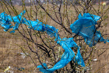 trash in the open air. Garbage bags on the trees.