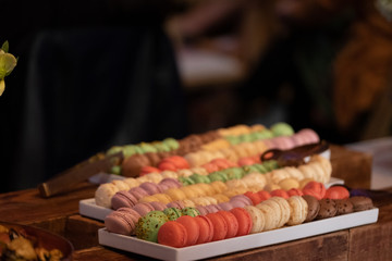 Macarons on a party serving tray, multi color, pistachio, chocolate, rose, lavender