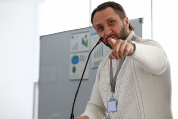 Male person speaking into microphone