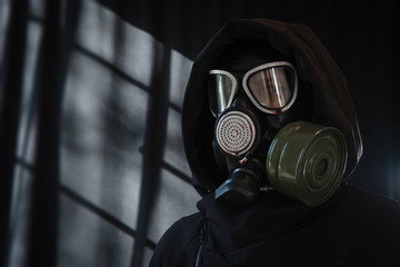 Portrait of a man in a full-face protective mask, a military gas mask with a wilt box. Respiratory...