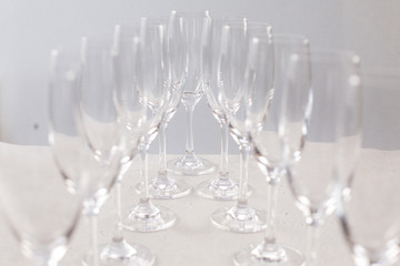 Glasses for champagne on a gray background, glass dishes for drinks