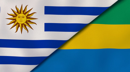 Fototapeta premium The flags of Uruguay and Gabon. News, reportage, business background. 3d illustration