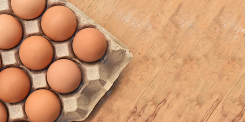 Top view Brown chicken eggs on wooden table soft focus.