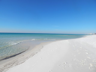 The pristine white sands and distinctively clear water of the Emerald Coast of Florida