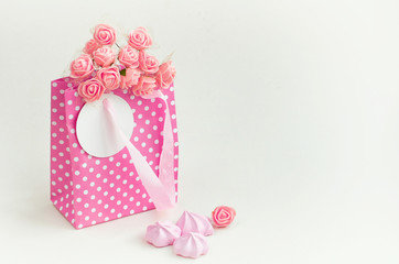 pink paper bag with bouquet of roses, holiday gift card