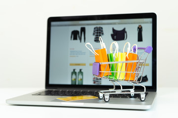 Shopping bag in a trolley on a laptop computer,Online shopping or ecommmerce concept