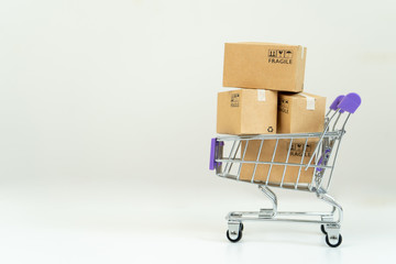 Paper boxes in a trolley with credit card on white background.Online shopping or ecommmerce concept