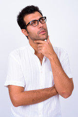 Portrait of handsome Turkish man with eyeglasses thinking