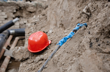 Connection of an electric cable underground after an accident at a construction site of a heating main. Twist or junction box electric cable on outdoor.