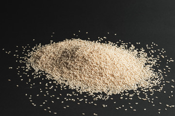 Seeds of white sesame on a black background