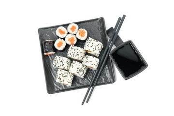 Tray with sushi rolls, chopsticks and soy sauce isolated on white background