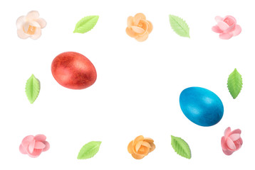 Easter still life with painted eggs and a sweet decor of flowers and leaves.