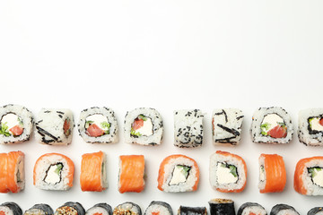 Flat lay with sushi rolls on white background. Japanese food
