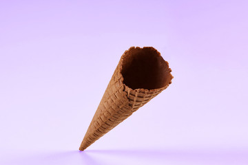 Empty, delicious, chocolate wafer cone for ice cream isolated on white. Concept of food, treats....
