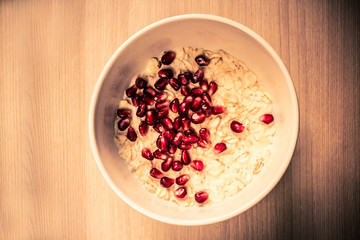 Oatmeal with pomegranate berries, a plate with breakfast