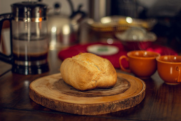 Breakfast table wood with coffee cups and hot bread.