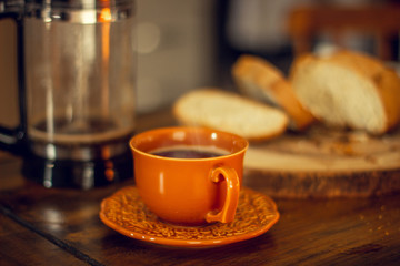 Breakfast table wood with coffee cups and hot bread.