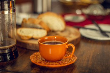 Breakfast table wood with coffee cups and hot bread.