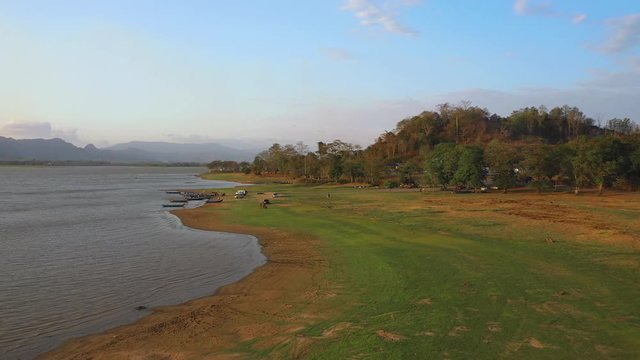 February 29th, 2020 - Perlis, Malaysia : 4k Establishing Aerial View Timah Tasoh Lake side During Beautiful Sunset with Mountain view. Drone Rising Tracking Left