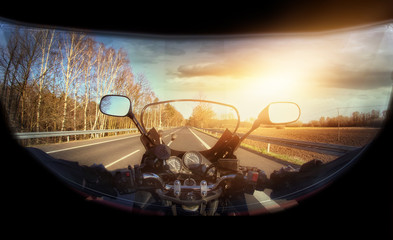 motorbike travel along the road with a view of the driver in a helmet
