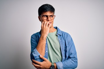 Young handsome man wearing casual shirt and glasses over isolated white background looking stressed...