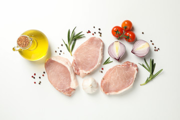 Composition with raw meat and ingredients on white background, top view