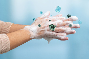 Conceptual hand wash eliminating virus cells.