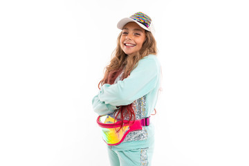 Little pretty caucasian girl in a tracksuit, picture isolated on white background