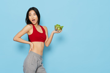 young woman holding a salad